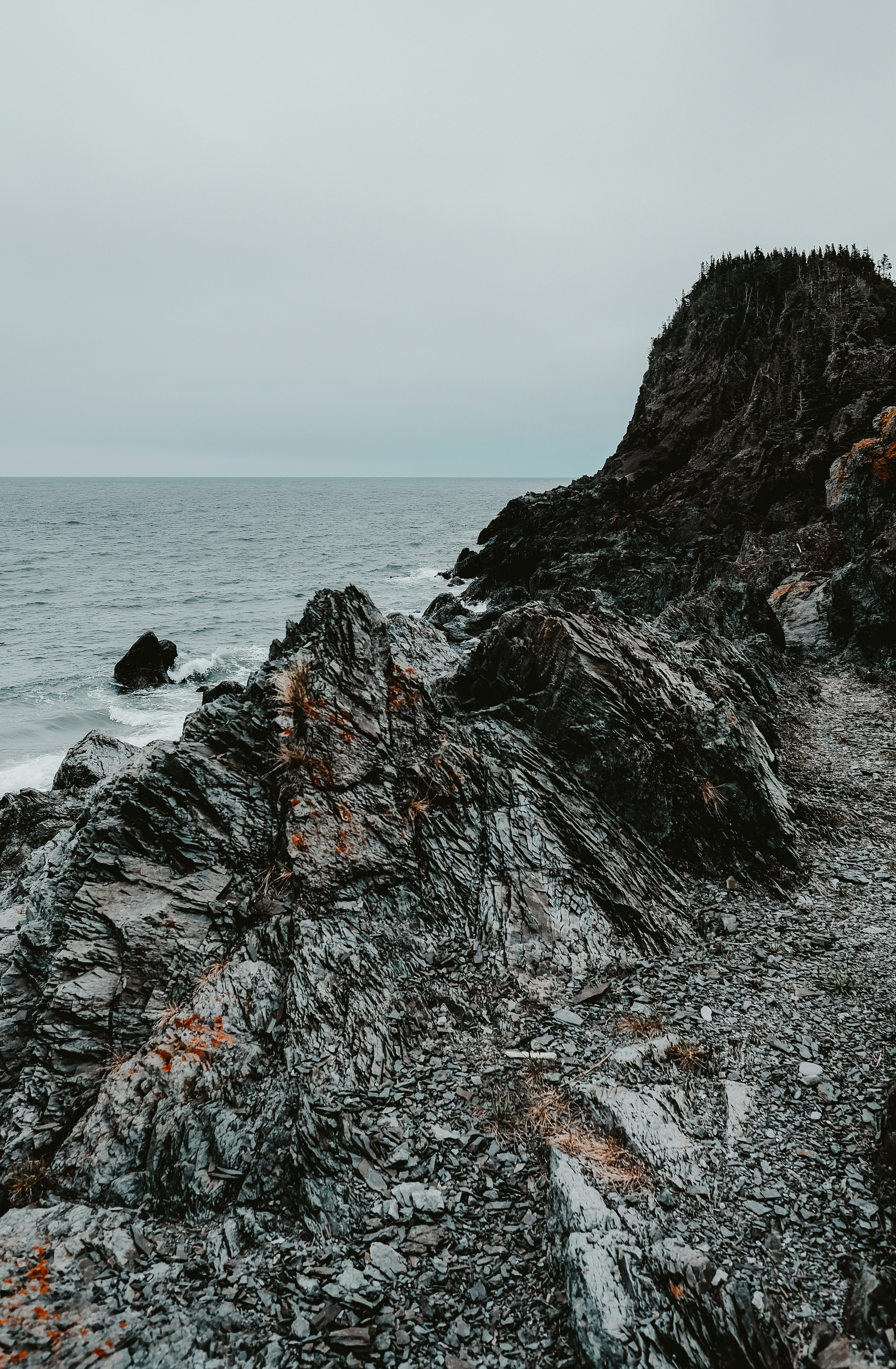 brown rock formation near body of water during daytime